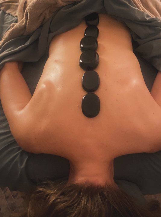 Hot stones laid along a client's spine